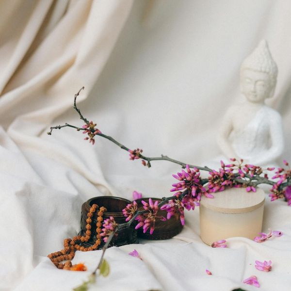 Woman in a calm yoga pose on a light lime background, symbolizing inner peace.